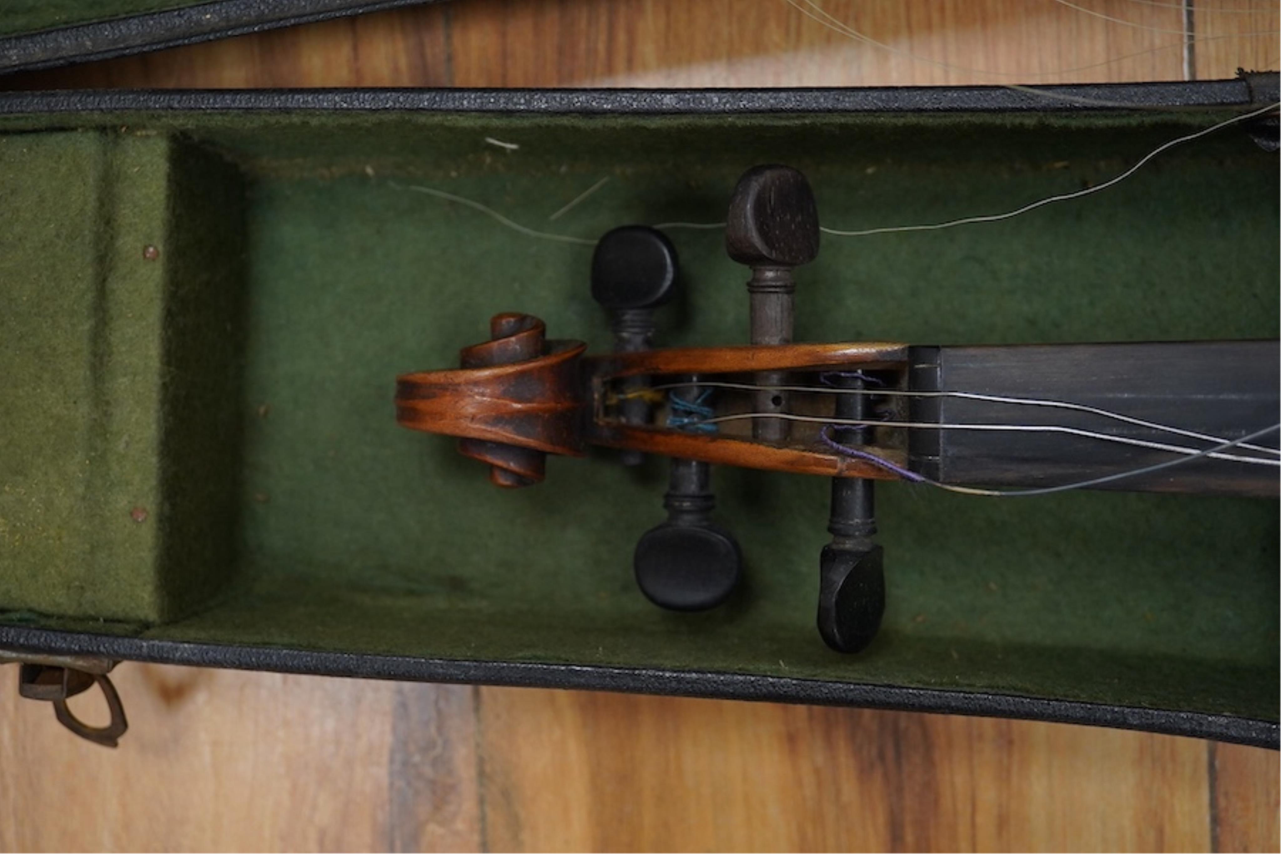 A late 19th cased century French unmarked violin and bow, body 35cm high.